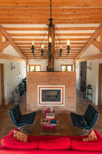 a living room with a fireplace and a table and chairs at Agriturismo La Cascina di Opaco in Norcia