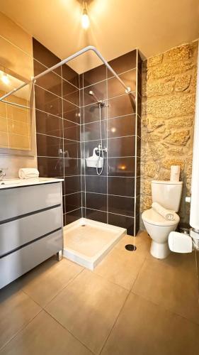 a bathroom with a shower with a toilet and a sink at Casa das Antas in Antas