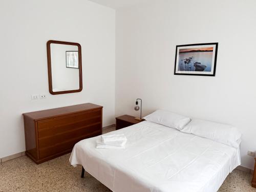a bedroom with a white bed and a mirror at Casa Lagò Lagò Panoramic Apartment in Ranzanico
