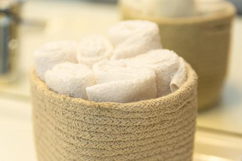 a container of toilet paper sitting on a counter at Green Mood - Design & Calme - Aux Portes de Paris in Asnières-sur-Seine