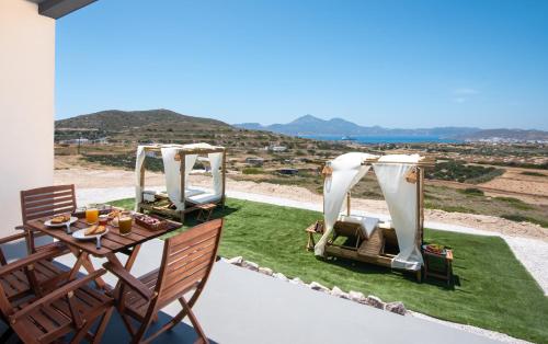 a patio with a table and chairs and a tent at Esperos Panoramic View Suites in Mytakas