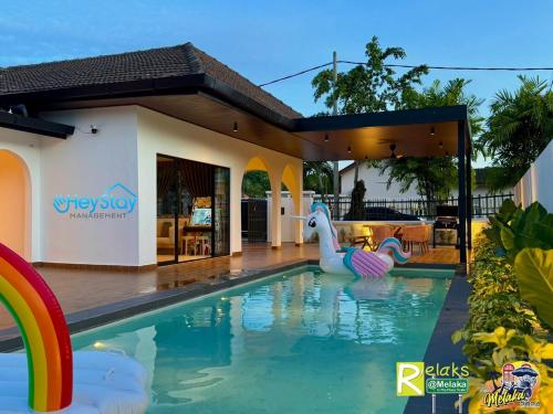 a pool with a plastic duck in the middle of a house at Villa 5R3B 23 Pax Swimming Pool Karaoke BBQ Town Area in Kelebang Besar