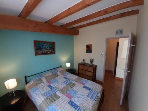 a bedroom with a bed in a room with wooden ceilings at Lotus in Cébazan