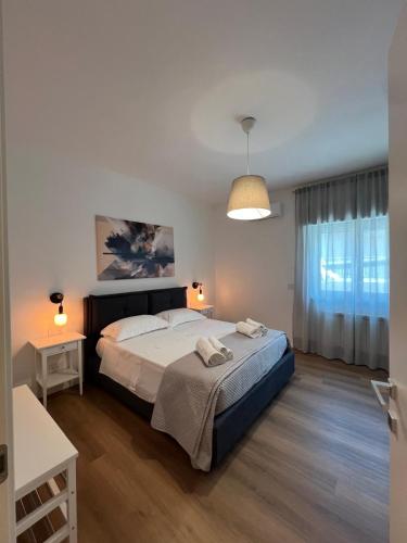 a bedroom with a large bed and a window at Ramò Apartments in Canicattì