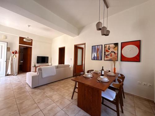 a living room with a table and a couch at Nostos Apartment Galatas in Galatas