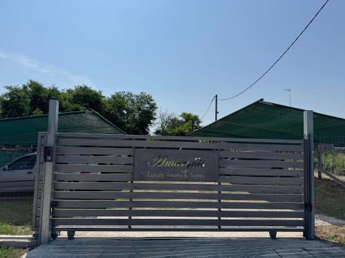 a wooden fence with a sign on it at Amaryllis Luxury Rooms in Platamonas