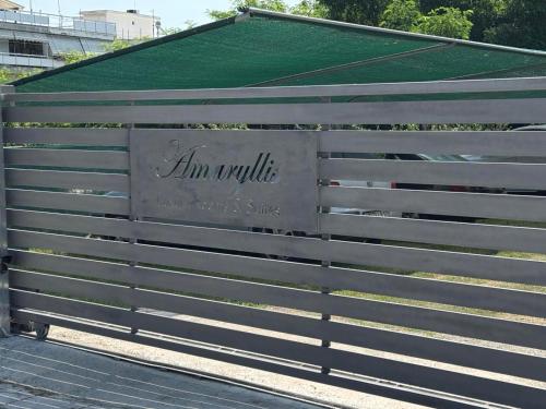 a fence with the words im neville on it at Amaryllis Luxury Rooms in Platamonas