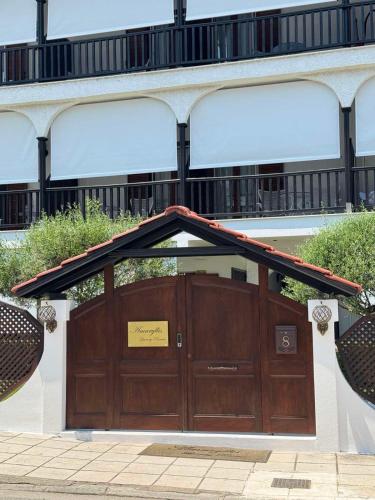 a large wooden garage door with a sign on it at Amaryllis House in Platamonas