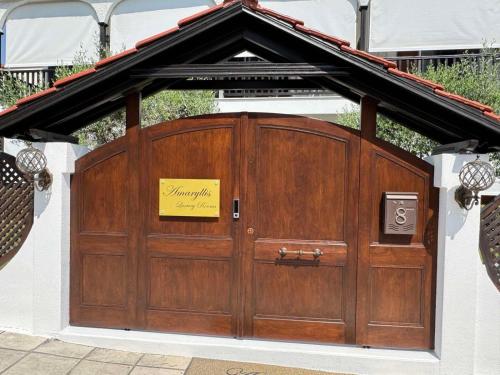 a large wooden garage door with a sign on it at Amaryllis House in Platamonas