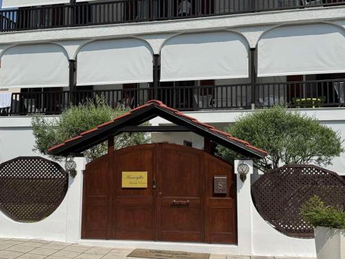a building with a wooden door in front of it at Amaryllis House in Platamonas