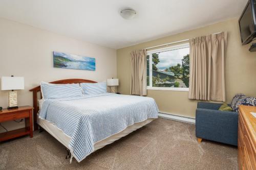 a bedroom with a bed and a window and a couch at Ocean Terrace Condominiums in Lincoln City