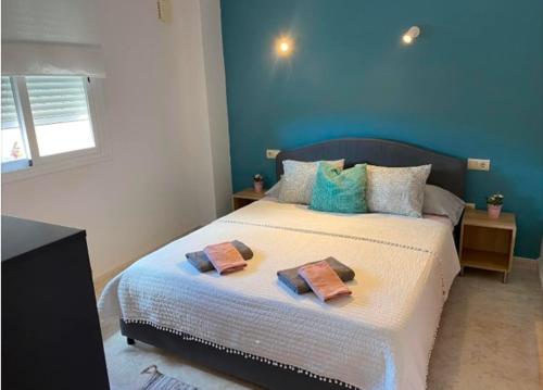 a bedroom with a bed with two towels on it at Apartmán Marcella, Cumbre del Sol in Cumbre del Sol