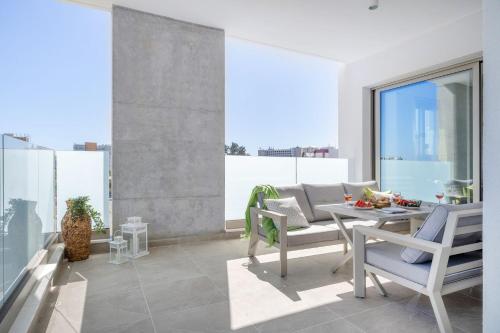 a living room with a table and chairs on a balcony at Mulberry Court Premium Apartments in Limassol