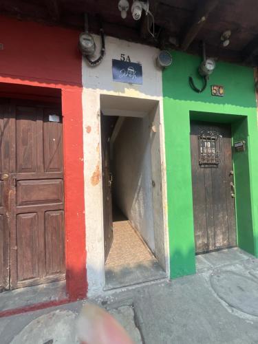 a building with two doors on the side of it at Jireh guesthouse in Antigua Guatemala
