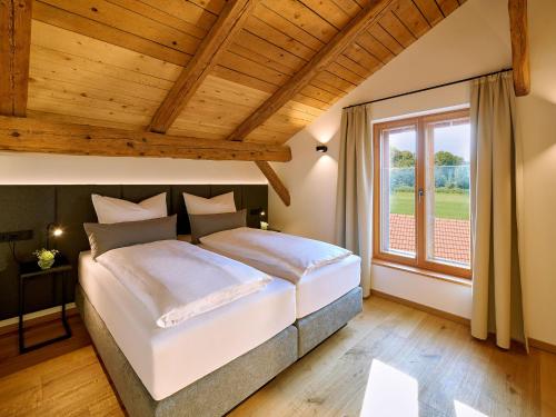 a bedroom with a large bed and a window at Moierhof in Gstadt am Chiemsee