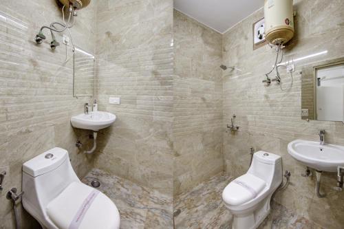 a bathroom with two sinks and two toilets at Hotel S B Inn Near New Delhi railway Station Paharganj in New Delhi