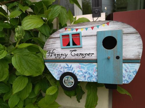 a bird house with a happy summer written on it at Blue Wellness Pools Saunas Appartement with Alpine view Balcony in Sankt Englmar
