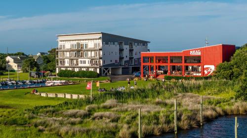 a building next to a river next to a building at Kite Point - Waterfront 2-Bedroom, 2-Bathroom Suite at REAL Watersports in Waves