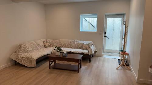 a living room with a couch and a table at Basement suite -Langley Willoughby in Langley