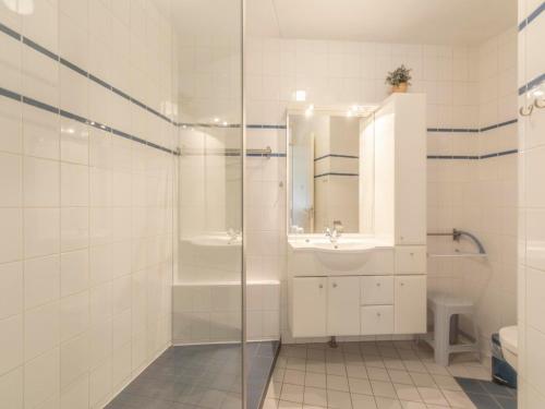 a bathroom with a shower and a sink and a toilet at Cozy Dune-View Apartment in De Zandloper