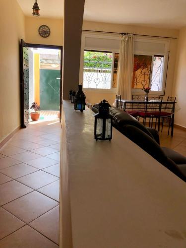 a living room with a couch and a table at APT traditionnel et très bien situé - WIFI & PARKING in Agadir