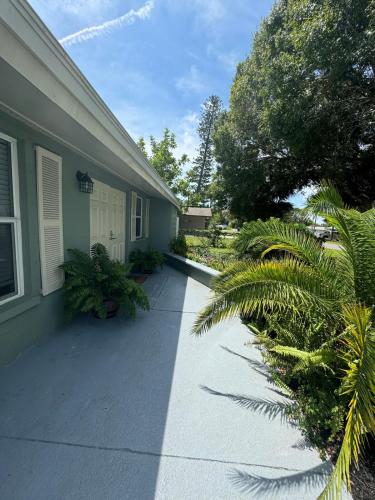 a house with a sidewalk next to a building at Beautiful house with jacuzzi near AnnaMariaIsland in Bradenton