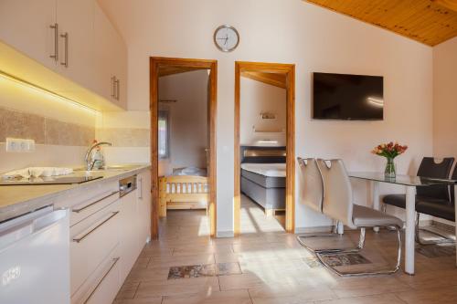 a kitchen with a sink and a desk with a table at Hullám Nyaraló in Balatonmáriafürdő