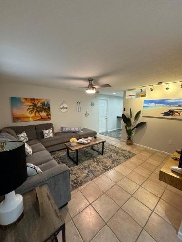 a living room with a couch and a table at Beautiful house with jacuzzi near AnnaMariaIsland in Bradenton
