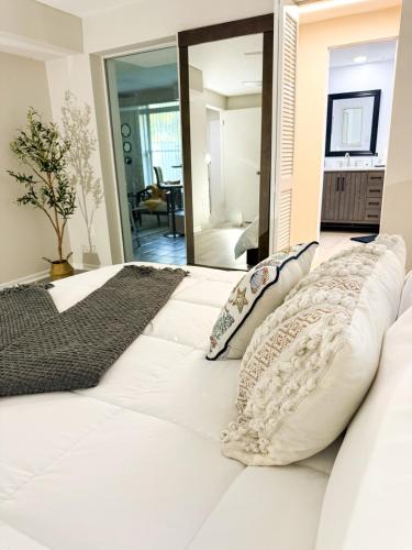 a white bed with pillows on it in a room at Beautiful house with jacuzzi near AnnaMariaIsland in Bradenton