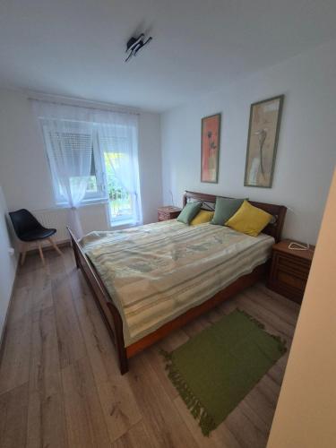a bedroom with a large bed and a window at Sandline in Kecskemét