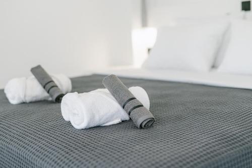 two rolls of toilet paper on a bed at Nysa Kea - A Cycladic House in Korissia