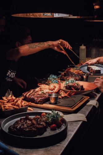 a table with many different types of food on it at Maison Grinder in Montréal