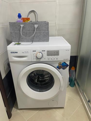a washing machine with a box on top of it at Breeze of Lalëz in Lalzit Bay