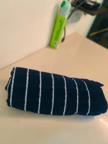 a blue and white toothbrush sitting on a table at Night View Apartment in Ghaziabad