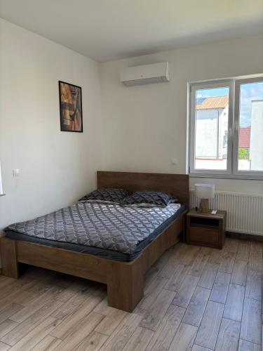 a bedroom with a bed in the corner of a room at Apartamenty Na Fali in Kołobrzeg