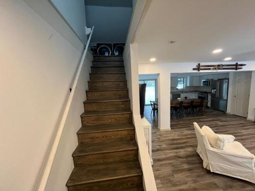 a stairway leading to a living room and a kitchen at Wolf Pond House 3 Miles to Lake Placid in Lake Placid