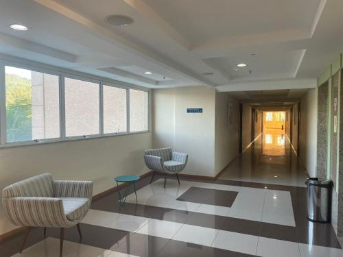 a waiting room with two chairs and a table at Flat Porto Marina Mont Blanc in Mangaratiba