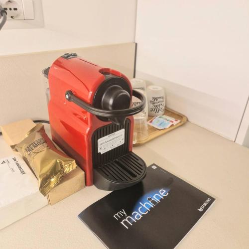 a red toaster sitting on top of a counter at Modern Viggi Suite Home in Viggiù