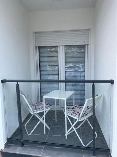 a table and two chairs on a balcony at Harizma lux centar in Popadić