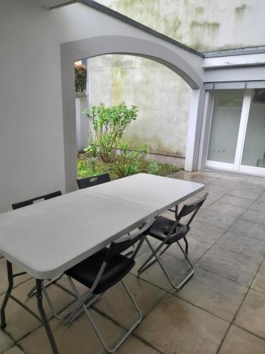 a white table and two chairs on a patio at Aura Smart Haus con terrazza in Melano