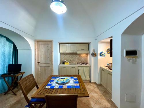 a kitchen with a table and chairs in a room at Residence Dammusi Riah in Pantelleria