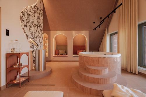a bathroom with a tub and stairs in a room at Casa Blush - LoftAffair Spa Collection in Gdańsk