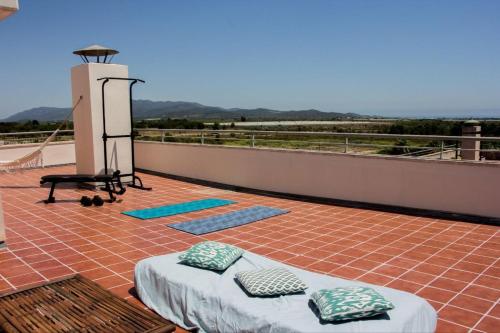 Un balcón con una cama y un calentador en un techo. en Ático Premium con Azotea, Pádel y Piscina, en Sant Jordi (San Jorge)