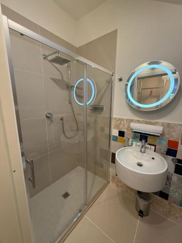 a bathroom with a shower and a sink and a mirror at IL CORSO apartment in Cesena