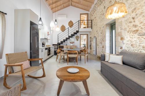 a living room with a couch and a table at Kefalas Luxury Villas Patitiri with Private Pool in Epáno Kefalás