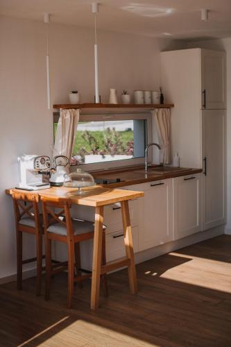 a kitchen with a wooden table and a sink at Warmiński Sad in Olsztyn