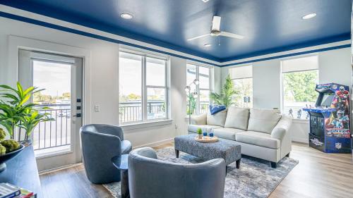 a living room with blue ceilings and a couch and chairs at The Rambler Inn in Arlington
