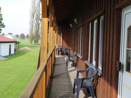 a row of benches on the side of a building at Spacious Apartment in Boddin with Garden in Boddin