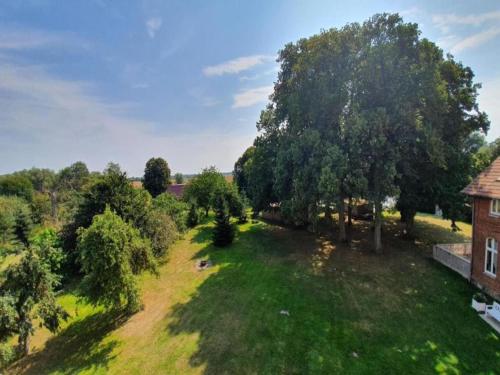 an aerial view of a yard with trees and a building at Spacious Apartment in Boddin with Garden in Boddin