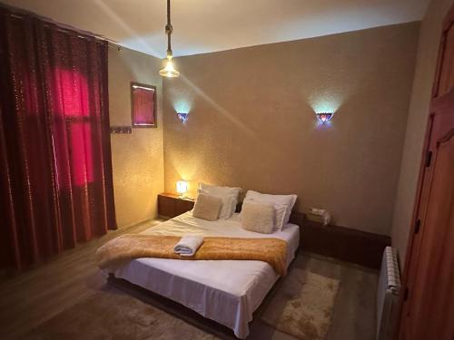 a bedroom with a bed in a room at DAR AL QANASS IMANE in Midelt